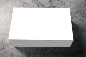 stack of white blank name card on cement background
