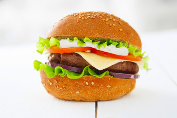 Tasty hamburger on the wooden table.