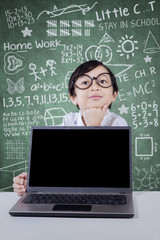 Girl thinking idea with laptop in class