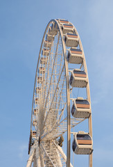 Giant Ferris wheel with blue sky background