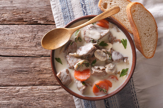 Beef with mushrooms in cream sauce in a bowl. horizontal top view
