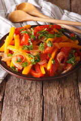 Piperade: peppers with tomatoes and onions close up. Vertical
