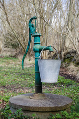 Hand water pump with a bucket