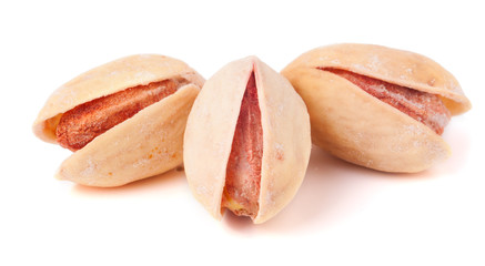 three pistachios isolated on white background closeup
