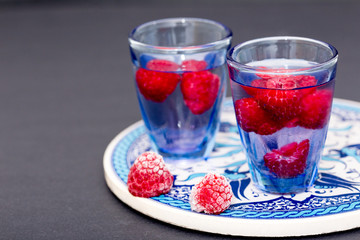 close up of a cold drink with raspberries.