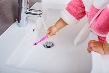 Child hand with toothbrush