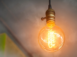 vintage light bulb glowing in the smoke