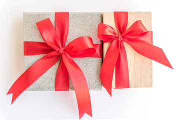 silver and wooden gift box with red ribbon bow