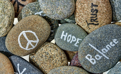 Hand Painted Messages and Symbols Adorn Colorful River Stones