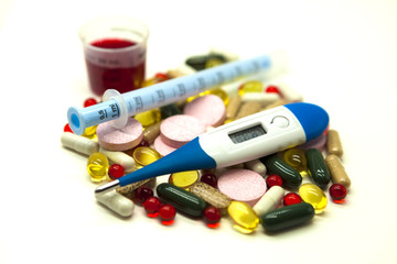 Different pills, medications   with medicine with a syringe and with thermometer on white background closeup.