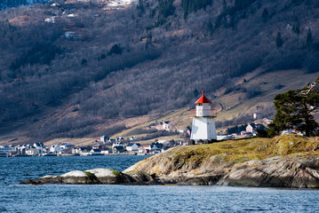 Fototapeta na wymiar Small lighthouse in a Norwegian fjord