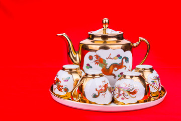 Generic traditional Chinese tea set with generic red envelope bearing the word double happiness, in white background
