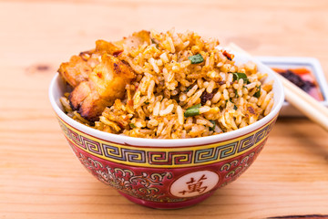 Closeup Chinese spicy fried rice with roast pork in bowl