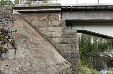 Steel construction and the old stone construction joined together on a Railway bridge in the North of Sweden. 