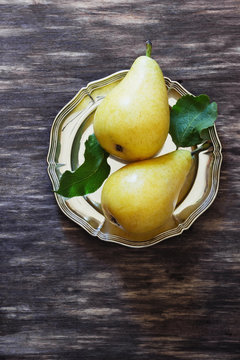 Organic ripe pear in vintage plate
