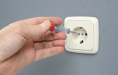 Checking if electrical wall outlet has voltage.