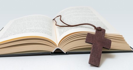 Brown cross and Holy Bible.