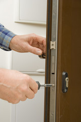 Locksmith replacing a cylinder lock