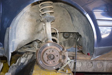Front disc brake on car in process of new timing belt replacemen