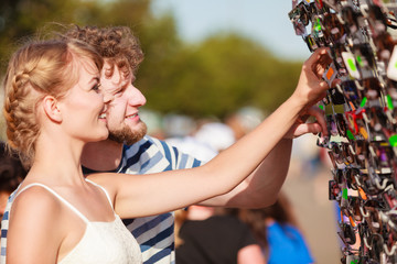 young couple buying new sunglasses outdoor
