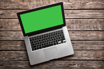 Open laptop with isolated green screen