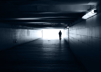 Lonely silhouette in a subway tunnel - Powered by Adobe