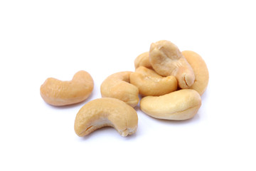 Pile of roasted salted cashews on a white background