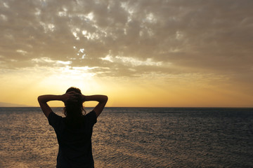 The woman silhouette with sunset