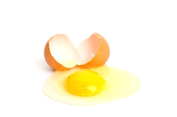 Broken egg with yolk, isolated on white background.