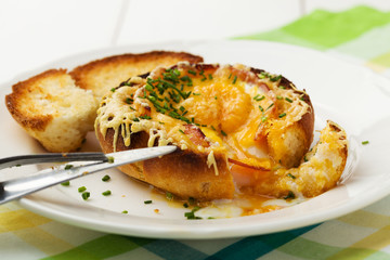Baked sandwich with egg, cheese and ham.