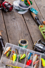 fishing tackles and baits on wooden board