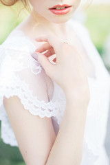 Close-up of bride in white laced dress