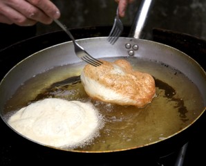 two pancakes in hot oil and the two forks of the restaurant