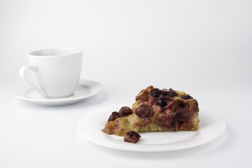 Cherry cake with a cup of coffee on a white background