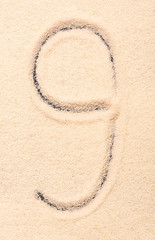 Fototapeta na wymiar 9 number written on sand
