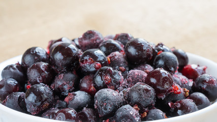 Frozen black berries in bowl. 