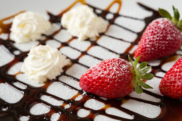 Close up of strawberries and whipped cream