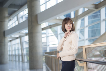 Fototapeta premium Attractive asian business woman smiling outside office