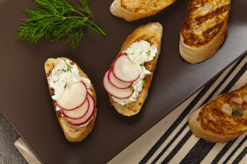 Bread Toasts with White Cheese and Radishes. Selective focus.