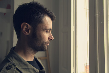 Man looking out the window