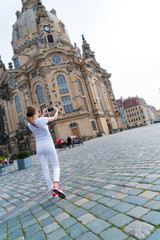 Young woman take photo Frauenkirche in Dresden