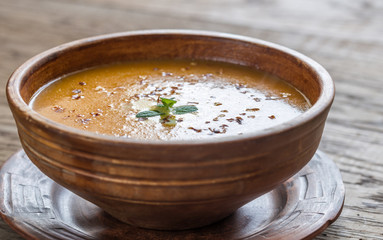 Bowl of spicy pumpkin cream soup on the wooden table