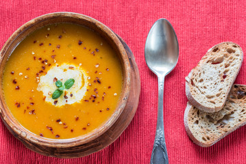 Bowl of spicy pumpkin cream soup: top view