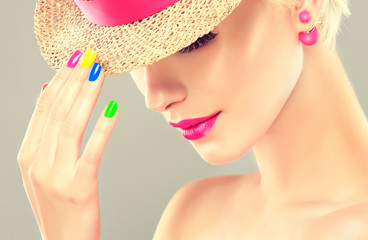 colorful makeup and manicure nails . Stylish blonde girl with bright makeup and colorful nail Polish on your nails . Spring and summer look  and  Earrings beads
