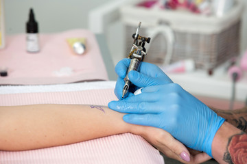 Tattoo artist at work close up
