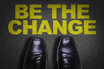 Top View of Business Shoes on the floor with the text: Be The Change