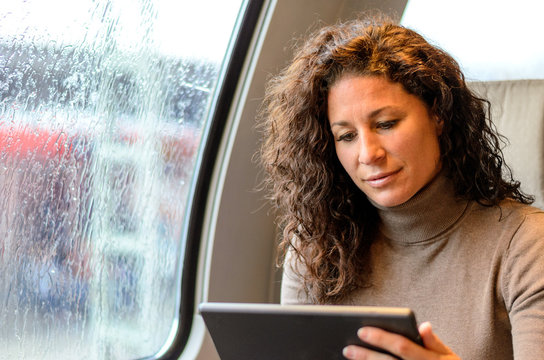 Young woman travelling on a train on a rainy day