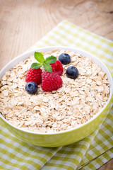 Oatmeal porridge with berries. Raspberries and blueberries.