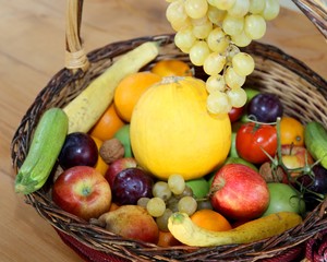 basket with lots of fresh fruit in autumn and winter season