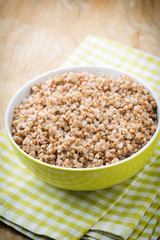 Buckwheat porridge in a bowl with mint leaves and blueberries.